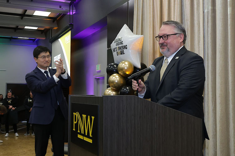 PNW Chancellor Chris Holford, right, is introduced by Purdue President Mung Chiang during the Excellence Evolving leadership celebration at PNW’s Hammond campus.