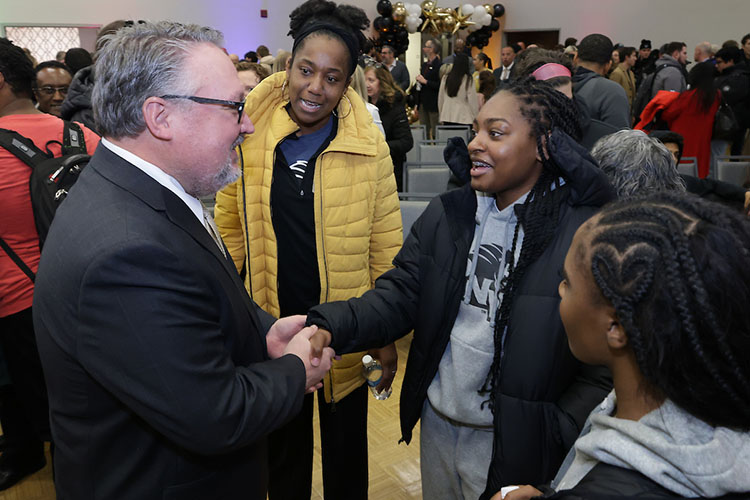 PNW Chancellor Chris Holford greets Pride women’s basketball team members during the Excellence Evolving event in Alumni Hall.