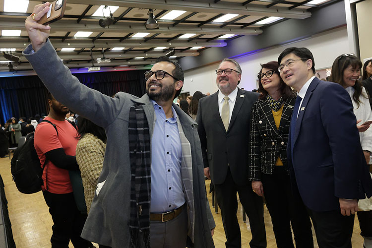 From left, Ramesh Neupane, director of International Programs and Partnerships; PNW Chancellor Chris Holford; Raida Abuizam, associate vice chancellor for Academic Affairs; and Purdue President Mung Chiang grab a selfie together during the Excellence Evolving leadership celebration in Hammond.