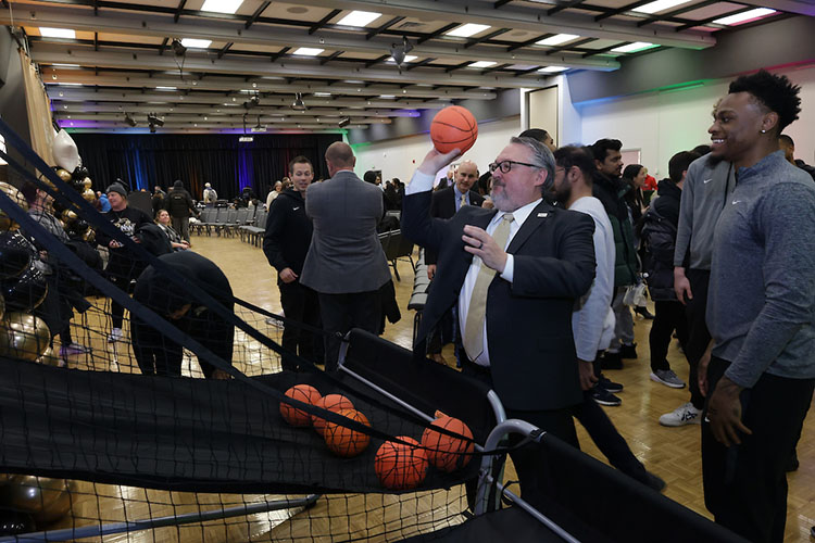 PNW Chancellor Chris Holford plays a friendly competition with Pride men’s basketball team members in “pop-a-shot” during the Excellence Evolving leadership celebration in Hammond.