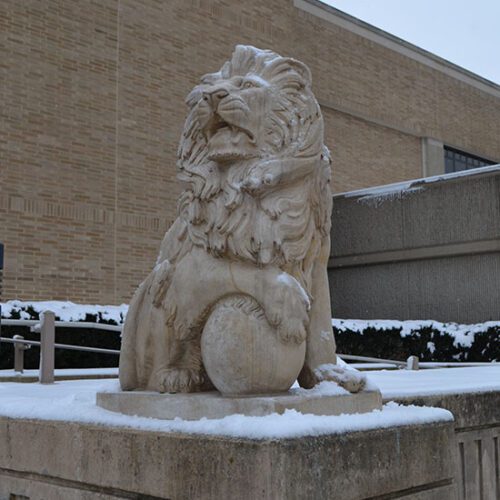 Lion statue covered in snow