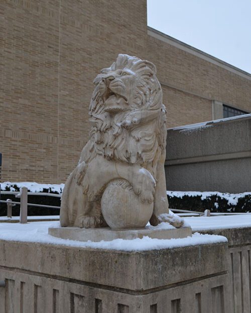 Lion statue covered in snow