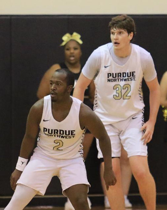 Two Purdue University basketball players in the middle of a game.