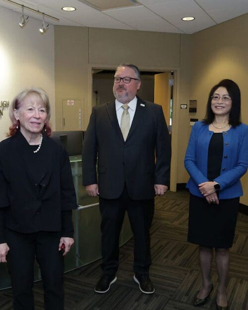 Geri Richmond, Chenn Zhou and Chris Holford stand in the CIVS lobby