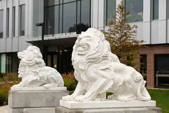 Statues of lions in front of Purdue University Northwest's NILS building.