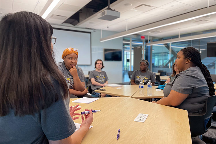 Students collaborate around a table.