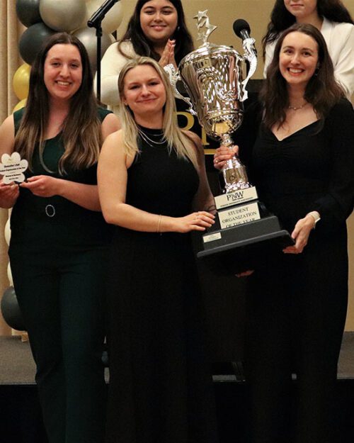 Students pose with their "Student Organization of the Year" trophy during the Chancellor's Ball