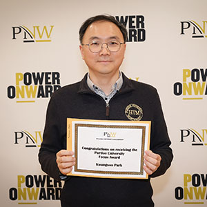 Kwangsoo Park holds recognition for his Purdue University Focus Award at Founders Day 2024.