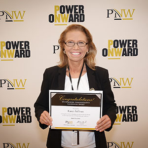 Karen Sullivan holds her Founders Day 2024 award.