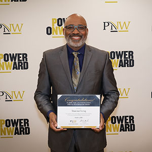 Shontrai Irving holds a Purdue for Life Foundation Special Boilermaker Award recognition at Founders Day 2024.