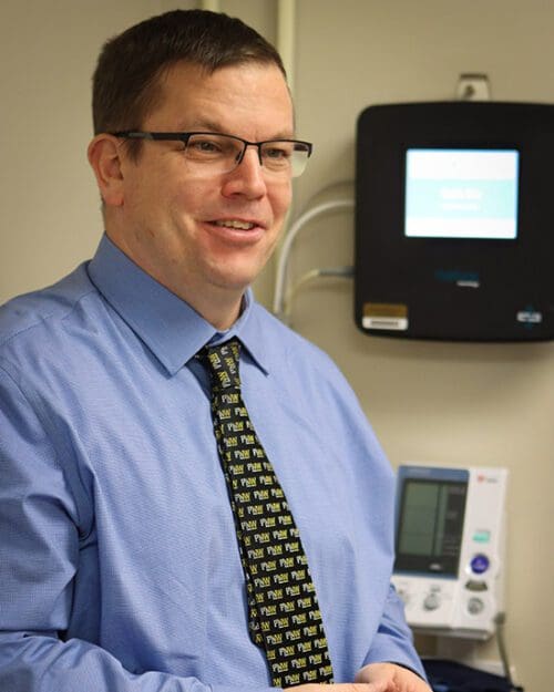 John Durocher stands in a lab