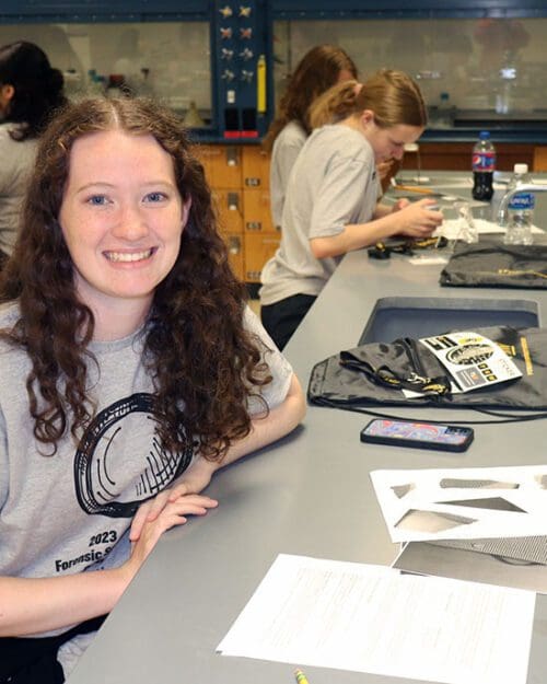 A student studies at a lab bench.