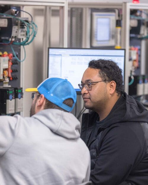 Two students work on a computer