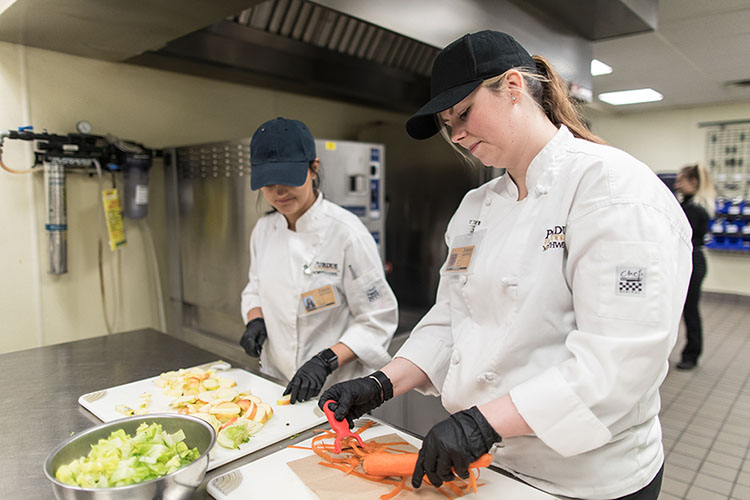 PNW Kitchen at the Hospital and Management Building with two students working