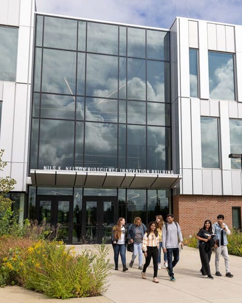 Students walk in front of the Nils K, Nelson Bioscience Innovation Building