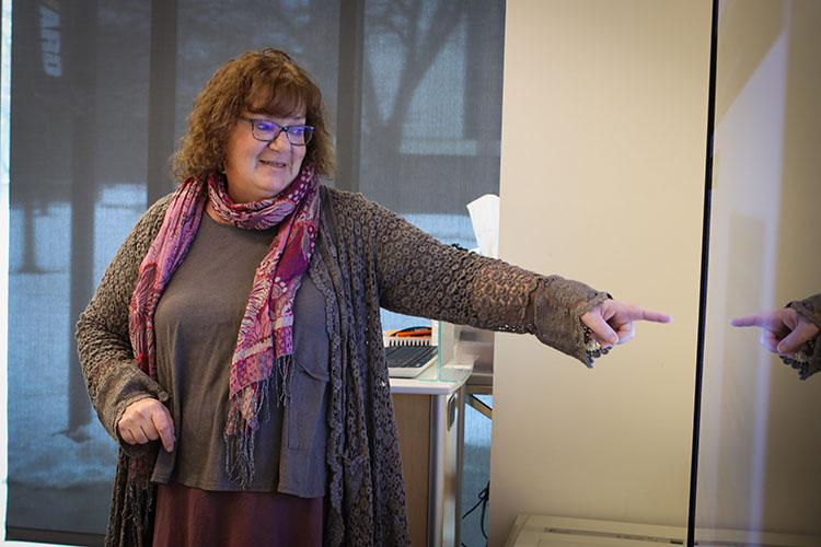 Beth Vottero points to a screen display