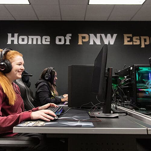 Students sit at desktop gaming stations in the PNW Esports Arena.