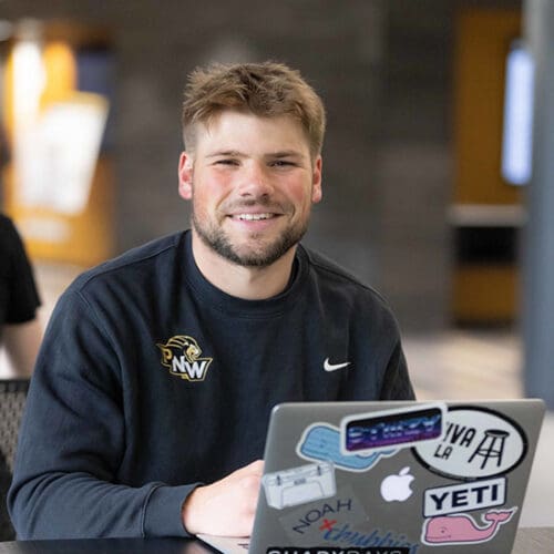 A PNW student works on a laptop