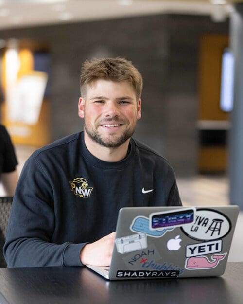 A PNW student works on a laptop