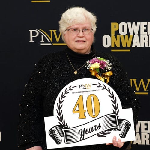 Deb Grant holds a "40 years of service" recognition.