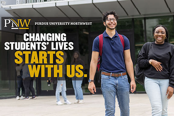 Two students with a "Changing Students' Lives Starts with Us"