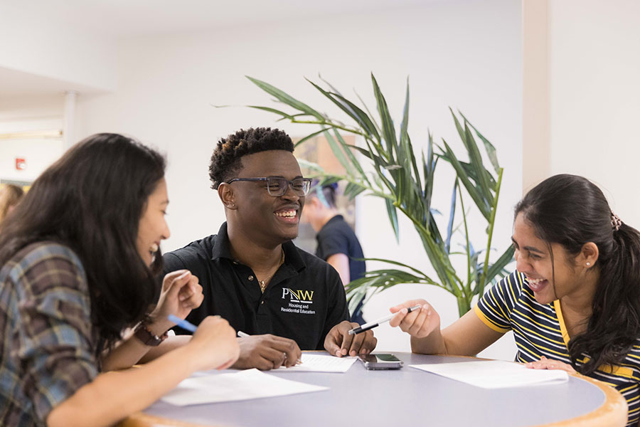 Students sit at a table in the University dorms
