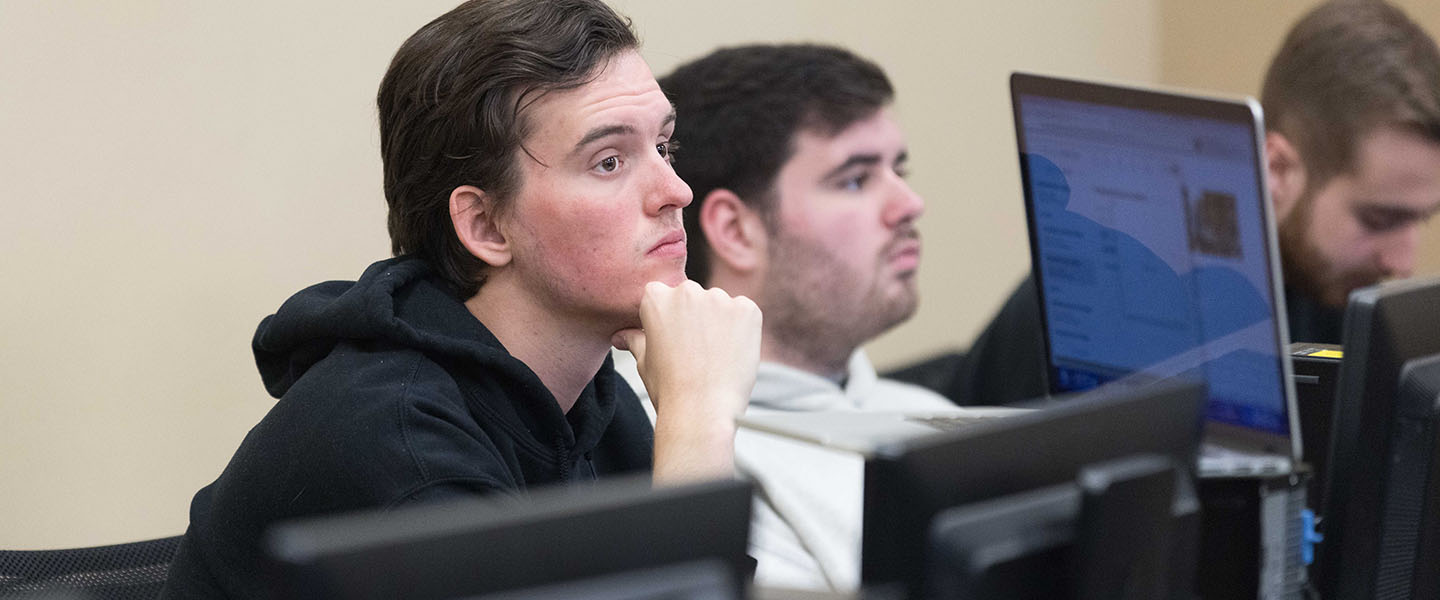 Two students sit at computers