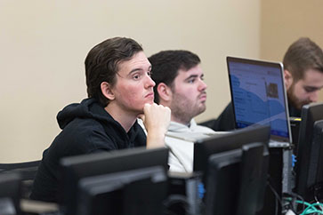 Two students sit at computers