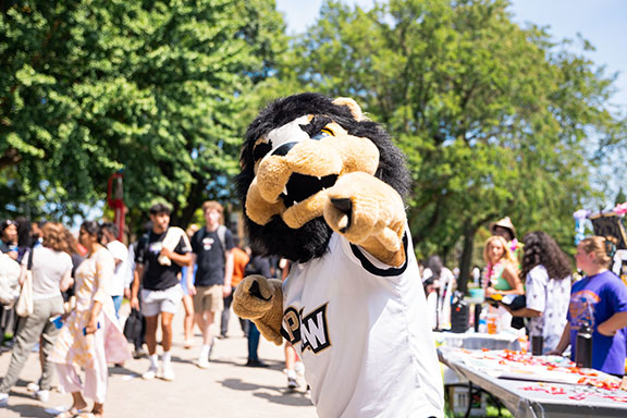 Leo the Lion points at the camera during a welcome rally