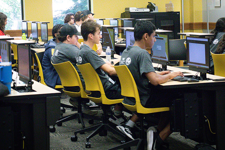 Students sit at computers during a summer camp