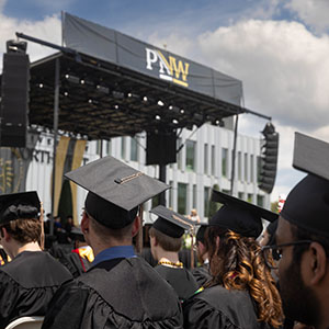PNW graduates sit in front of the stage at commencement