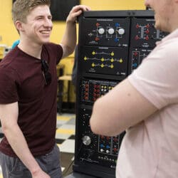 Two students work at a power electronics learning station