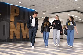 PNW students walk through a lounge area