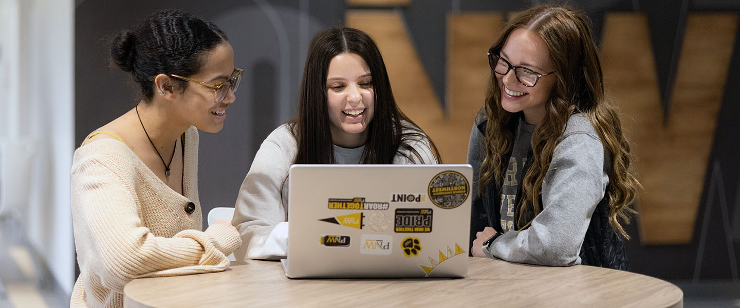 PNW students collaborate over a laptop