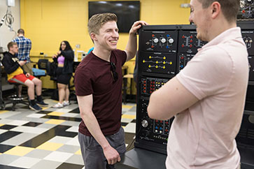 Two students work at a power electronics learning station
