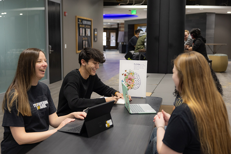 Four students talking to each other in CLO - Psychology Club