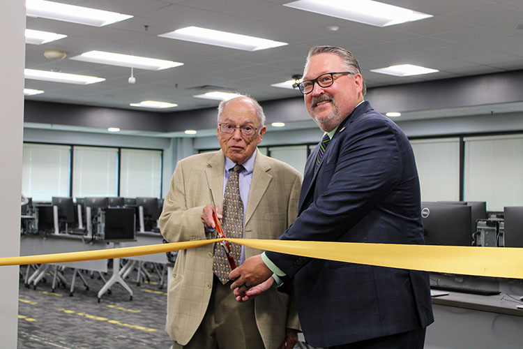 Horacio John Sori cuts a ribbon with Kenneth C. Holford.