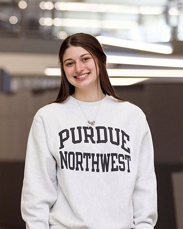 A student stands in a Purdue Northwest sweatshirt