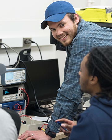 Students collaborate with lab equipment