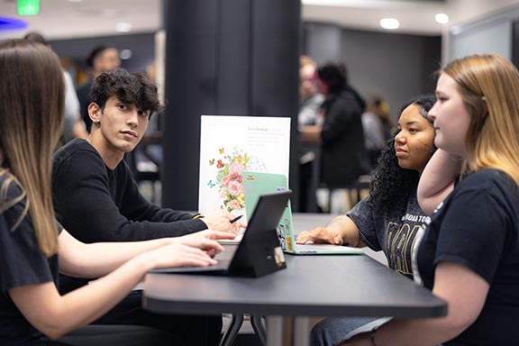 PNW students work around a conference table