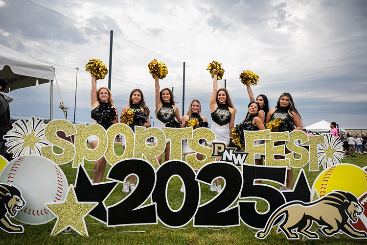 The PNW dance team poses behind a "Sports Fest 2025" sign