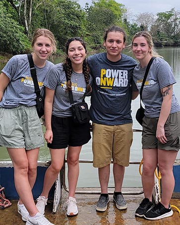 PNW students pose near a river in Costa Rica