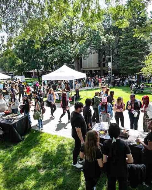 Students, faculty and staff gather outdoors on the PNW Hammond Campus