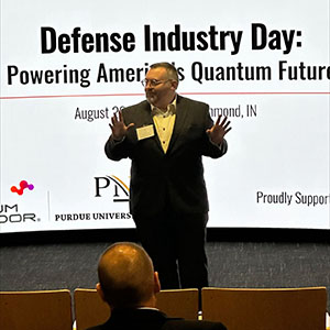 Matt Wells speaks in front of a crowd. 