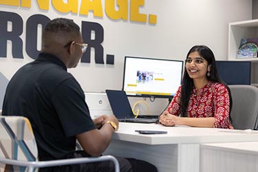 A PNW student meets with a student support staffer