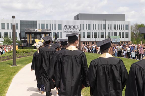 PNW students process for outdoor commencement