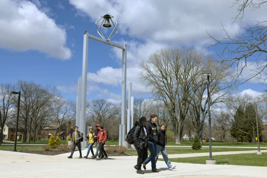 PNW students walk in front of the Bell Tower