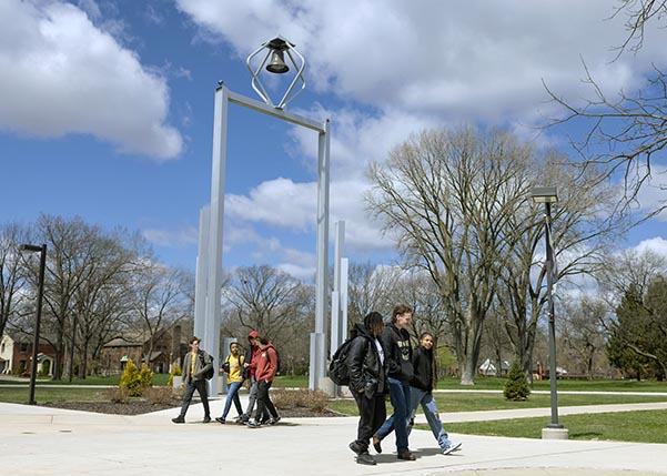 PNW students walk in front of the Bell Tower
