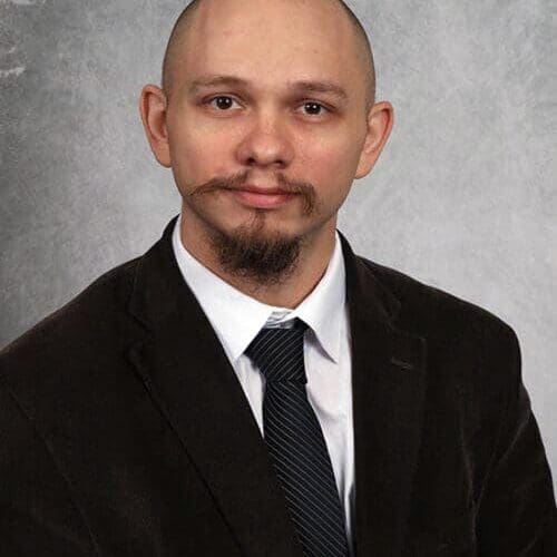 Professor Mitchell Howell in suit and tie