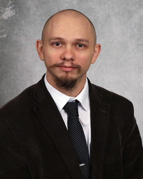 Professor Mitchell Howell in suit and tie